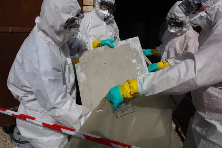 Staff removing some asbestos in a post of transformer